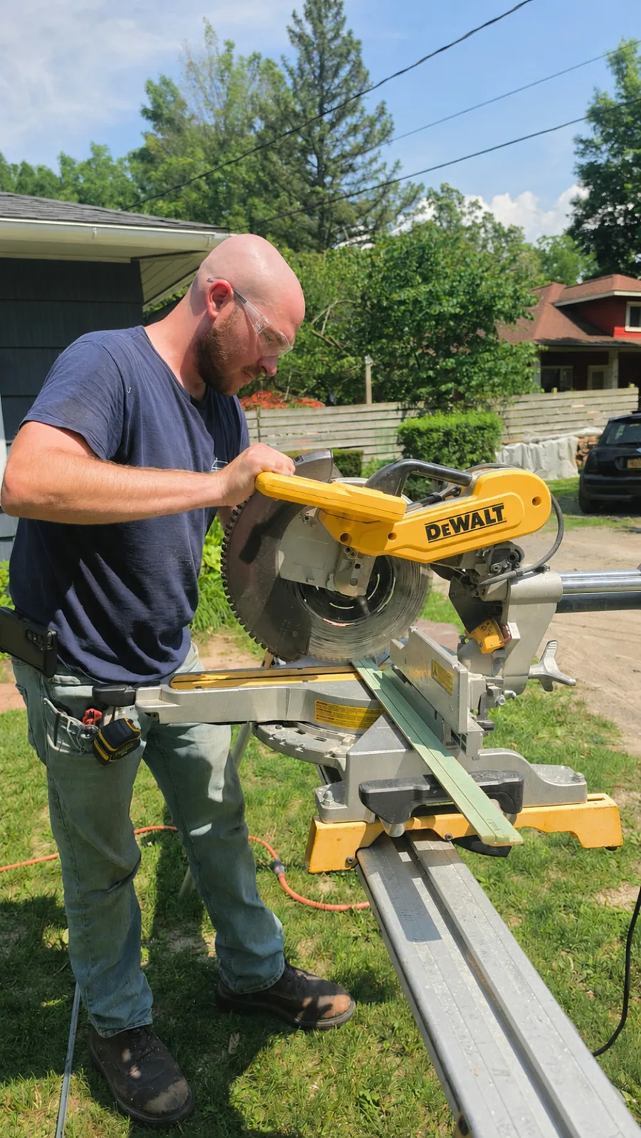Adam, founder of Drexler Home Services, working at a miter saw