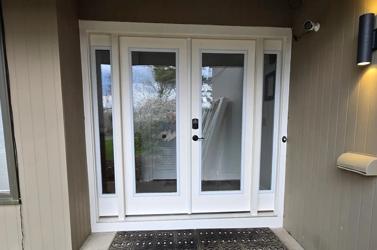 New white full-glass French double entry doors with sidelights by Drexler Home Services in Rochester NY