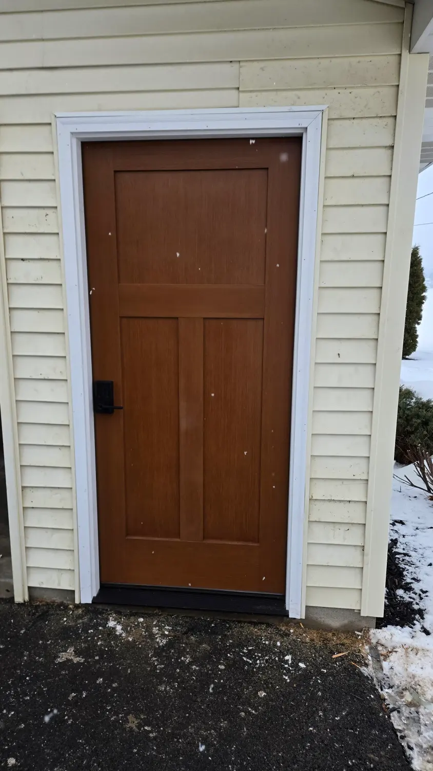 New craftsman-style wood-grain fiberglass door by Drexler Home Services near Sodus NY