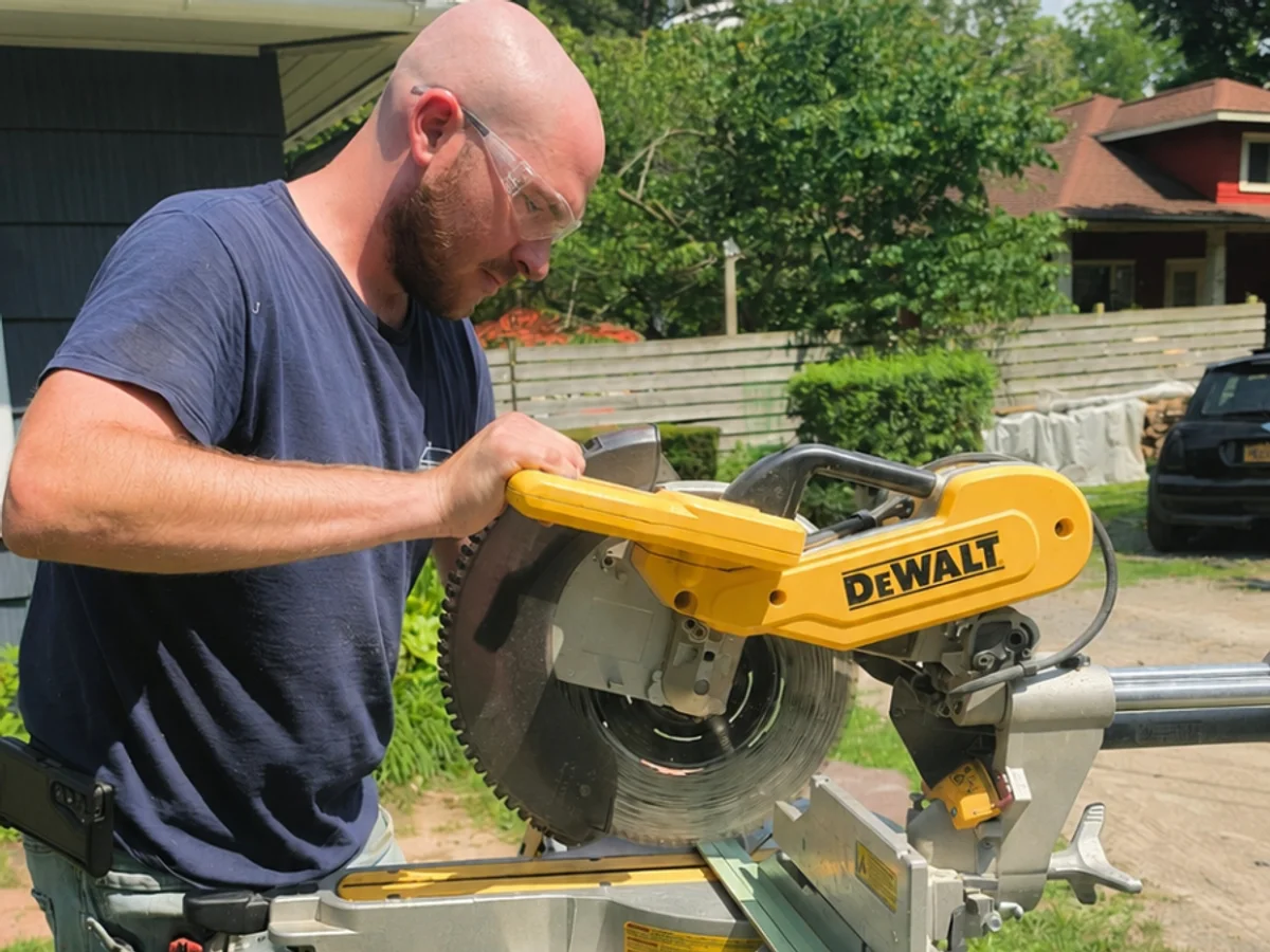 Adam Drexler cutting material for an outdoor home improvement project