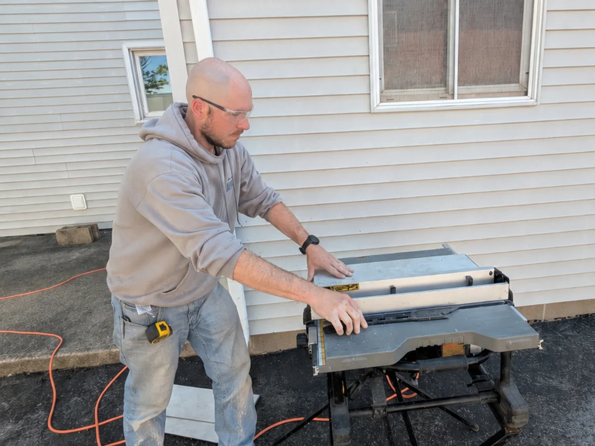 Adam Drexler preparing exterior trim beside a window installation